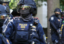 Riot police officer in tactical gear with helmet and visor