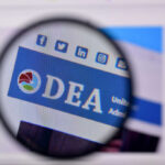 DEA Let Fentanyl Flow — Why? Magnifying glass focusing on DEA website header