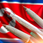 Missiles in front of a North Korean flag