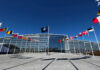 NATO’s Nuclear Map About To Change? NATO headquarters with member flags in front under a clear blue sky
