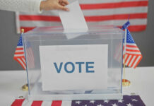 Name Doppelgänger Throws Alaska Into Turmoil Hand placing ballot in box with American flags