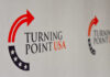 Tense Standoff Engulfs Conservative Summit Logo of Turning Point USA displayed on a backdrop