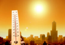 Europe Faces More Than Just Heat Thermometer displaying high temperature against a sunset city skyline