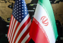 Iran Backpedals — What’s Really Signed? Flags of the United States and Iran displayed together