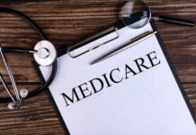 Runaway Fraudster Dragged Back to Court A document labeled 'Medicare' with a stethoscope and magnifying glass on a wooden surface