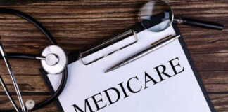 A document labeled 'Medicare' with a stethoscope and magnifying glass on a wooden surface