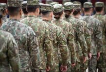 Trans Troops Ruling Explodes In D.C. Soldiers in camouflage uniforms standing in formation from behind