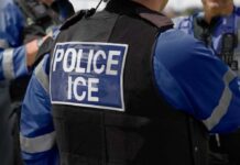 Protest Turns Riot: State Police Take Perimeter Close-up of a police officer's vest with 'POLICE ICE' label
