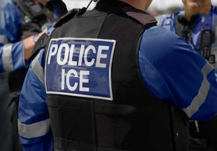 Ice,Police,Agent,-,Officer,Of,Immigration,And,Customs,Enforcement. Close-up of a police officer's vest with 'POLICE ICE' label