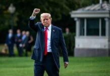 Birthday Brawl Overshadows Oil Shock Twist A political figure raising a fist while walking outdoors