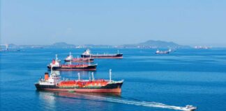 Several cargo ships navigating in a calm ocean