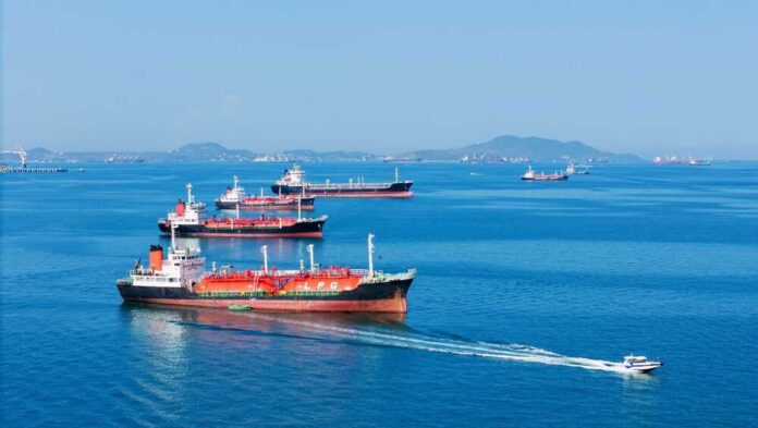 Lpg,Gas,And,Oil,Tanker,Ships,Anchored,In,The,Ocean, Several cargo ships navigating in a calm ocean