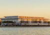 Modern riverside performing arts center at sunset