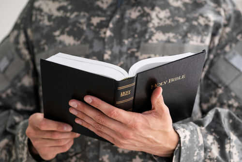 soldier-and-bibble1772909846jpg Person in uniform holding an open Bible