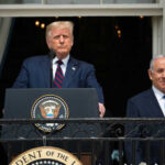 U.S. Call Stops Raids — What Changed? Two men standing at a podium outdoors
