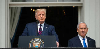 Two men standing at a podium outdoors