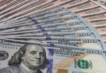Millionaire Hype Exposed—Here’s What Works A close-up view of a stack of hundred dollar bills arranged neatly