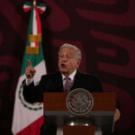 New Allegations Put Mexico’s Former Leaders Under Scrutiny Man speaking at podium with Mexican flag behind him