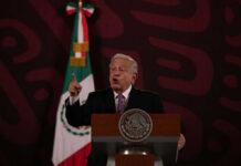 New Allegations Put Mexico’s Former Leaders Under Scrutiny Man speaking at podium with Mexican flag behind him