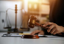 New Court Fight Intensifies in Kirk Murder Case Judge's hand holding a wooden gavel above a sound block