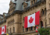 Canada’s World Cup Fever Takes Over Vancouver Historic building with large Canadian flags displayed outside