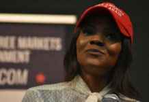The Charlie Kirk Debate Takes Another Turn Woman in a red baseball cap holding a microphone