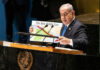 Netanyahu Faces His Biggest Political Test Yet Speaker at UN podium holding a Middle East map