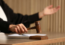 State Clemency Collides With Federal Enforcement Judge's hand striking a wooden gavel on a block