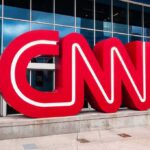 CNN red logo sculpture outside a modern glass building