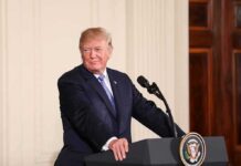 Dinner Mic Drop: 2028 Tease Ignites Frenzy man at podium with presidential seal