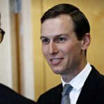 Drug Money Allegations Shake Kushner Resort Deal A man in a suit smiling while engaging in conversation indoors