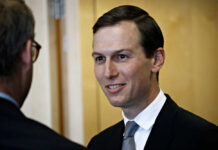 Drug Money Allegations Shake Kushner Resort Deal A man in a suit smiling while engaging in conversation indoors