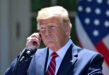 Trump Returns After Dinner Attack Shook Washington man in suit at podium adjusting earpiece