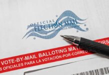 Appeals Court Freezes Trump Mail-Vote Push Official election mail envelope with pen
