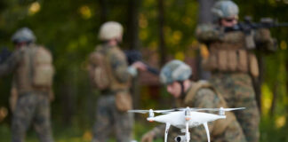 A military drone being prepared for use with soldiers in the background