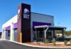 Taco Bell restaurant exterior with drive-thru and patio seating