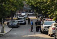 Fatal Madison Police Shooting Sparks Public Protests Police officers secure a residential street with patrol cars and yellow tape