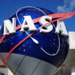 Hell Planet Breathes — Scientists Stunned NASA logo displayed on a large globe structure