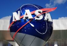 Hell Planet Breathes — Scientists Stunned NASA logo displayed on a large globe structure