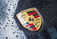 Porsche crest on wet car hood