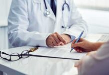 doctor and patient reviewing and signing medical form