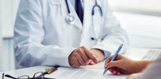doctor and patient reviewing and signing medical form