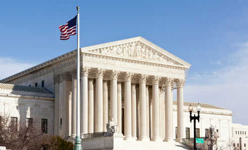 supreme-court_96721225 United States Supreme Court building with American flag