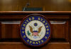 DSA Calls For A Constitutional Overhaul United States Senate emblem on wooden podium