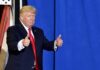 Trump Stops Mid-Speech, Then Flips the Script man in suit giving two thumbs up