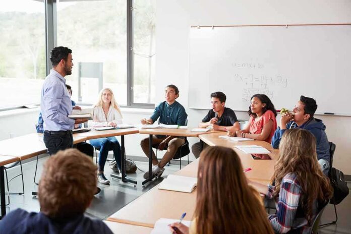 Teacher speaking to students in a classroom discussion