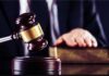 Guilty Plea Fight Reopens Idaho Murder Case Judge's gavel striking block with hand on book in background