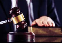 Guilty Plea Fight Reopens Idaho Murder Case Judge's gavel striking block with hand on book in background