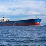 New Hormuz Deal Could Test America’s Red Lines A large cargo ship sailing on the ocean under a blue sky