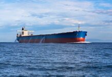 New Hormuz Deal Could Test America’s Red Lines A large cargo ship sailing on the ocean under a blue sky
